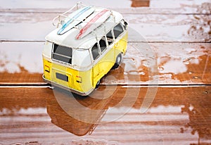 A bus toy on the wood in raining day