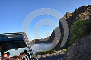 A bus travels the serpentine road in the mountains on the Canary Island of Tenerife, Spain