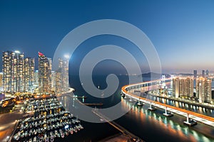 Busan city skyline in Haeundae business district area skyline view from roof top at night in Busan ,South Korea. Asian tourism,