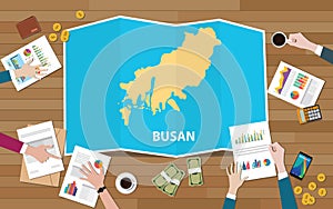 Busan pusan south korea city region economy growth with team discuss on fold maps view from top