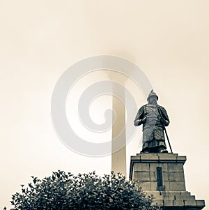 Busan Tower and Statue of Admiral Yi Sun-sin in front on a foggy day. Jung-gu, Busan, South Korea. Asia