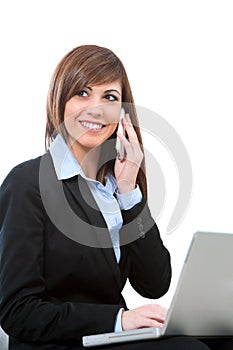 Buseness woman talking on phone with laptop.