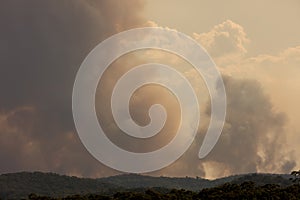 Bush fire smoke at sunset in a valley in The Blue Mountains in Australia