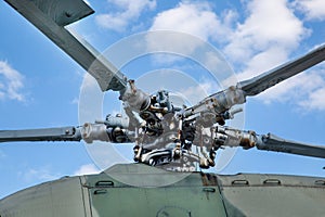Bushings and automatic-skew helicopter gray against the background of clouds on a clear sunny day