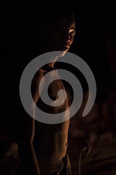 Bushman in fire light