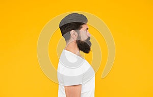 Bushy beard hipster man barbershop client yellow background, perfect side view concept
