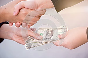 Businees handshake with money