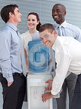 Busines colleagues talking around water cooler photo