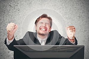 Busines man screaming at the computer, emotion, expression