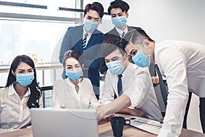 Busines people wearing face mask and  Business meeting in modern office while pandemic of virus photo