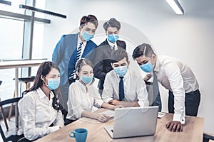 Busines people wearing face mask and  Business meeting in modern office while pandemic of virus photo