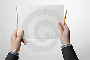 Business A4 paper notepad in businessman hands. Empty white page of document