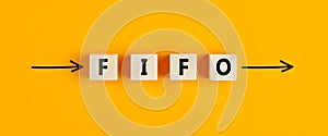 The business abbreviation fifo first in first out written on wooden blocks with directional arrows