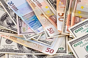 Business abstract background - banknotes of dollars and euros close-up