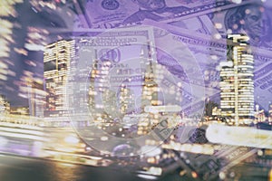 Business abstract background - of nightly skyscrapers and scattered banknotes dollars