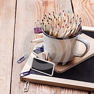 Business accessories, supplies, mug with pencils on rustic wooden table