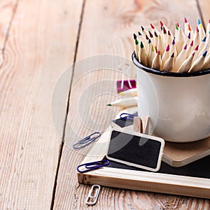 Business accessories, supplies, mug with pencils on rustic wooden table