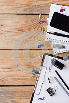 Business accessories, supplies, phone on rustic wooden table