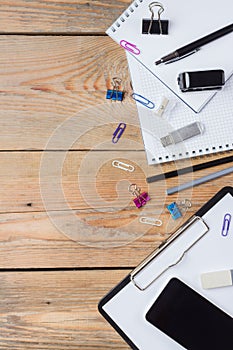 Business accessories, supplies, phone on rustic wooden table