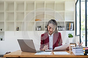 business accountant woman doing finances and calculate on desk about cost at office.