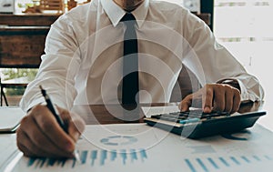 Business accountants point growth graph using calculator calculate financial at coffee shop,  finance accounting concept