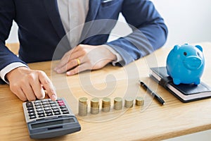 Business accounting man hands working stacking coin the calculator, calculating, financial investment planning and saving concept