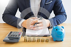 Business accounting man hands working stacking coin the calculat