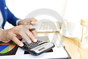 Business accounting plan concept, Working on desktop laptop computer with calculator for making business, business man hand