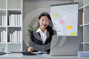 Business accounting woman counting on calculator working on financial document in hands closeup. Bookkeeping concept