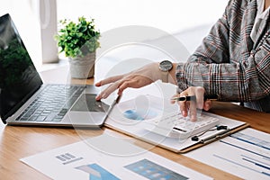 Business accounting woman working in finance and accounting Analyze financial budget in the office.