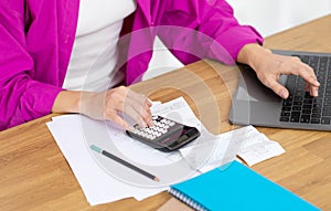 Business Accounting. Young Businesswoman Using Calculator And Working With Laptop,