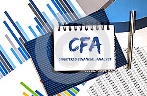 Business Acronym CFA - Chartered Financial Analyst. Text on notebook with chart.Conceptual image