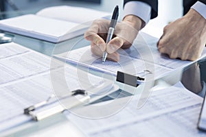 Business adviser analyzing financial figures denoting the progress in the work of the company.