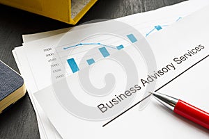 Business advisory services concept. A stack of financial charts and a folder. photo