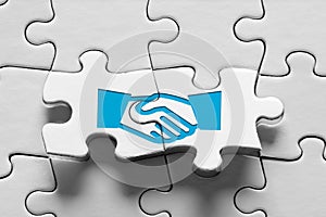Business agreement, consensus, strategic alliance or partnership. Jigsaw puzzle piece with handshake icon