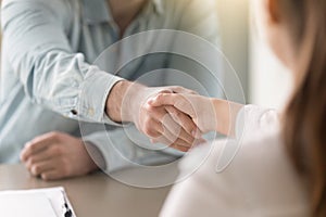 Business agreement handshake of man and woman at the office