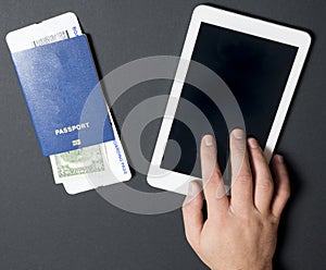 Business air travel, mobility and communication concept: tablet pc or buying airliner tickets online. Passports with boarding pass