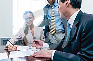 Business analyst smiling while interpreting financial reports