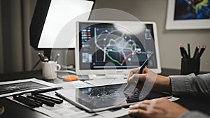 Business Analyst Using Digital Tablet with Data Charts in Modern Office