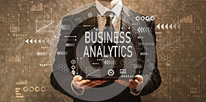 Business analytics with businessman holding a tablet computer