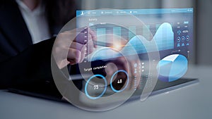 Business analytics visualization with graphs and data representation on digital tablet screen in modern office
