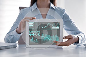 Business analytics. Woman working with tablet in office, closeup