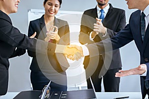 Business asian team people shaking hands after finishing up meeting in conference room