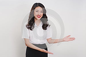 Business asian woman doing welcome gesture on a white background