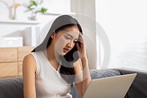 Business Asian woman have a Migraine so headache and stresses have a trouble and problem of her work.Frustrated woman.Office