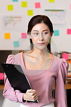 Business asian woman holding bord for note job in office