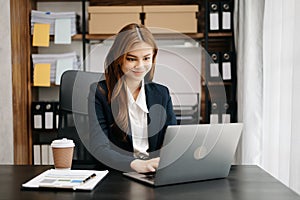 Business asian woman using tablet and laptop for doing math finance on an office desk, tax, report, accounting, statistics, and