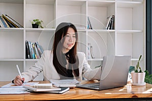 business asian woman working with laptop for financial document in office. female accountant doing accounting and