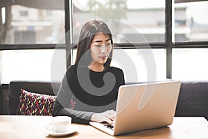 Business asian women using tablet computer to work with financial data in the work space. Business Concept