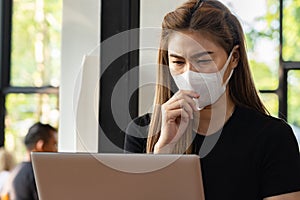 Business Asian young woman working with computer laptop and wearing protection mask coughing be congested with virus infection